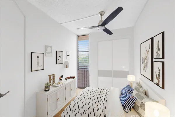 a bedroom with a bed and a chandelier