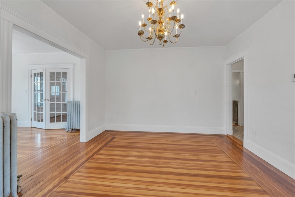 31 Justin Road, Unit 3 Boston, MA 02135 - Photo 11 of 32 wooden floor in an empty room with a window