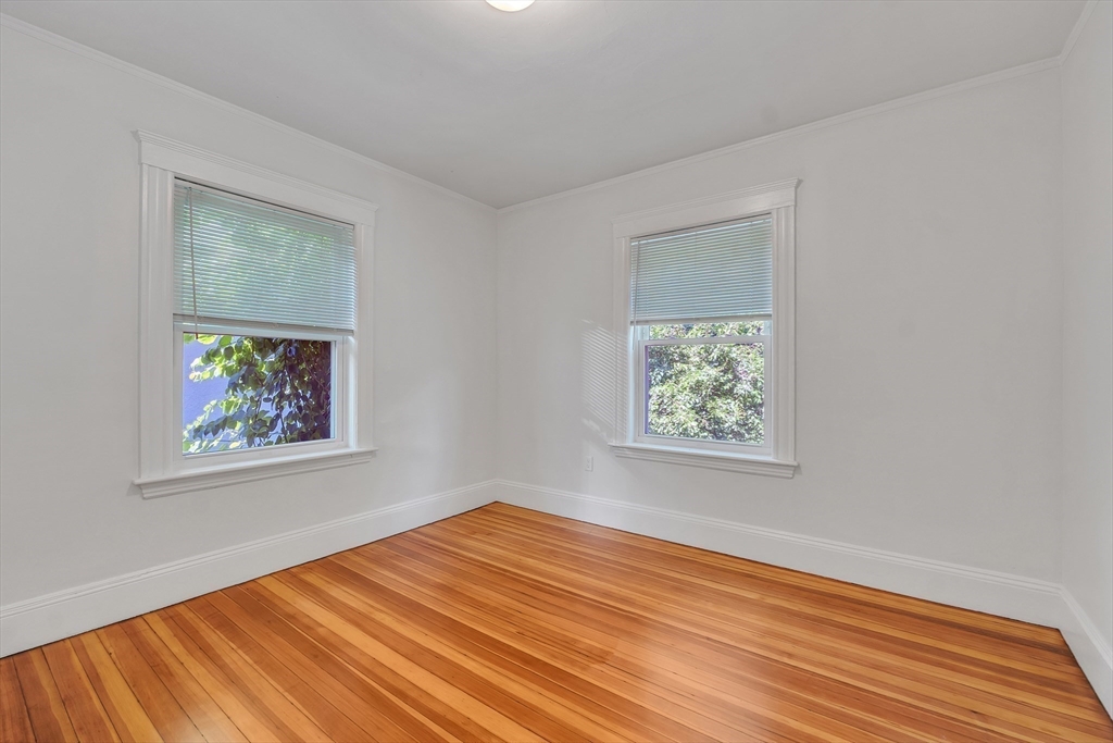 31 Justin Road, Unit 3 Boston, MA 02135 - Photo 13 of 32 a view of empty room with window and wooden floor