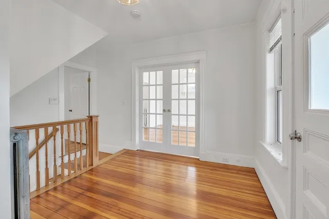 a view of a room with wooden floor and windows