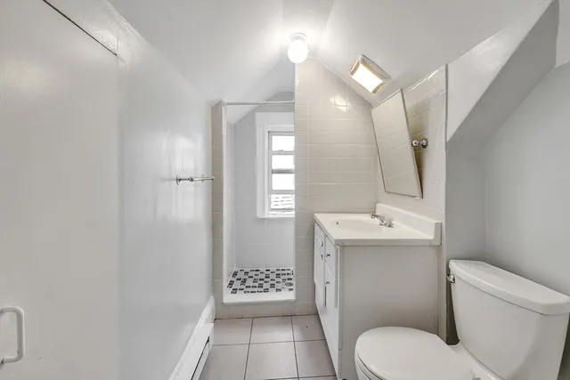 a bathroom with a toilet a sink and mirror