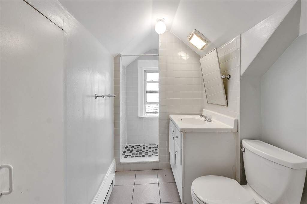 31 Justin Road, Unit 3 Boston, MA 02135 - Photo 22 of 32 a bathroom with a toilet a sink and mirror