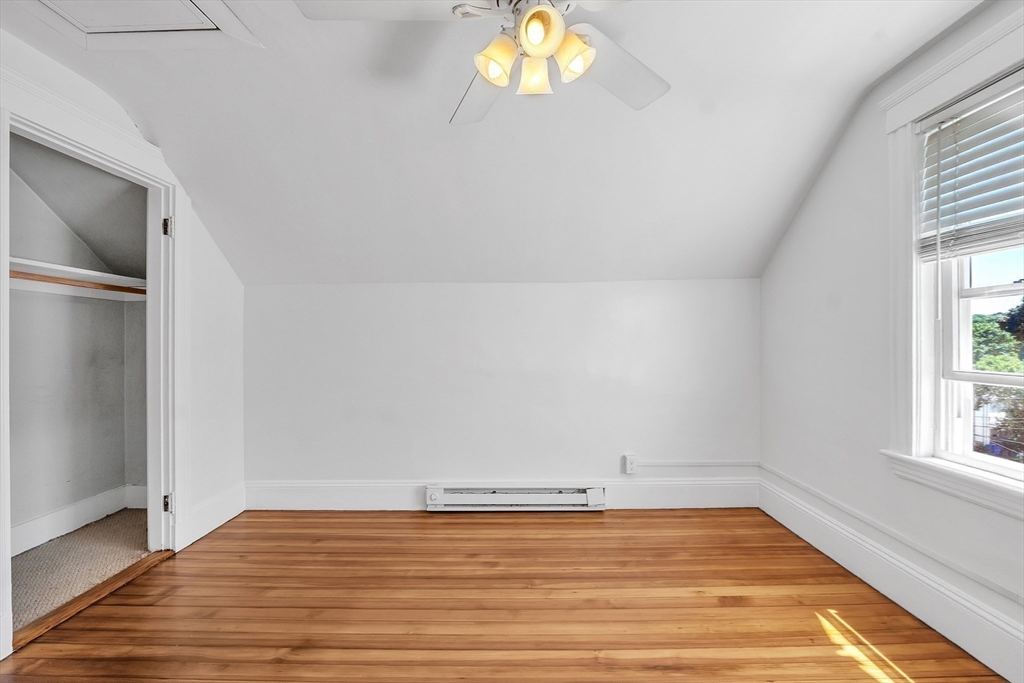 31 Justin Road, Unit 3 Boston, MA 02135 - Photo 24 of 32 an empty room with wooden floor and windows