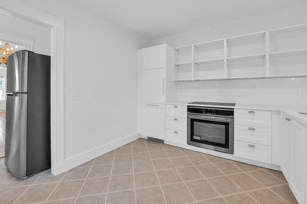 31 Justin Road, Unit 3 Boston, MA 02135 - Photo 3 of 32 a room with a cabinets and stainless steel appliances