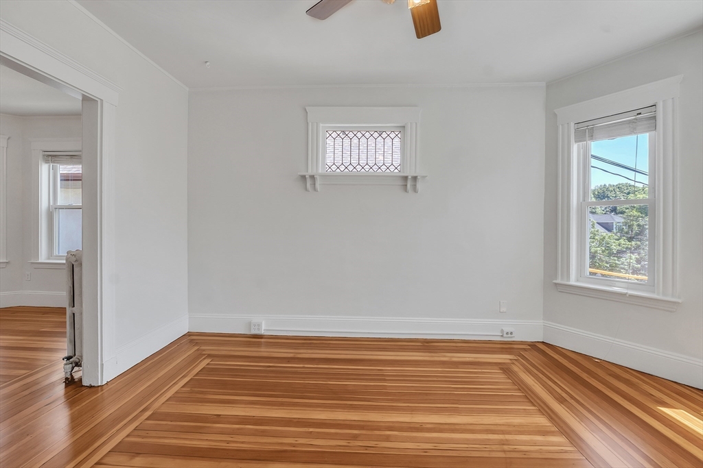 31 Justin Road, Unit 3 Boston, MA 02135 - Photo 8 of 32 a view of an empty room with wooden floor and a window