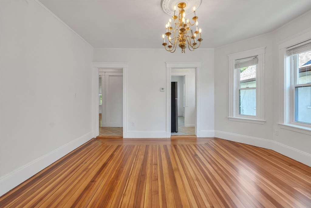 31 Justin Road, Unit 3 Boston, MA 02135 - Photo 10 of 32 a view of a room with wooden floor and chandelier