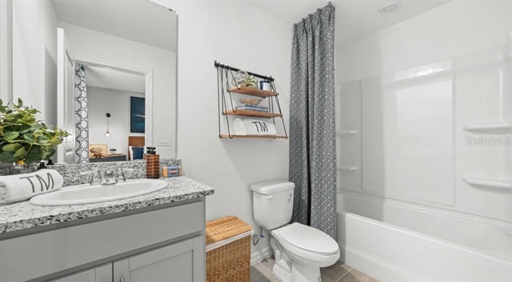 14060 Textile Run Parrish, FL 34219 - Photo 12 of 23 a bathroom with a granite countertop sink mirror vanity and toilet