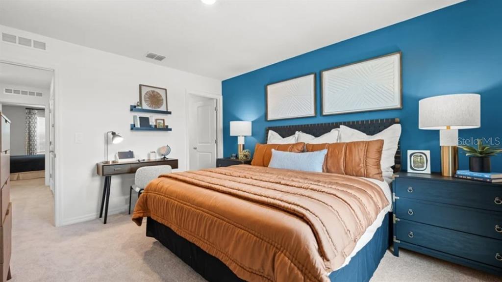 14060 Textile Run Parrish, FL 34219 - Photo 7 of 23 a bedroom with bed and wooden floor