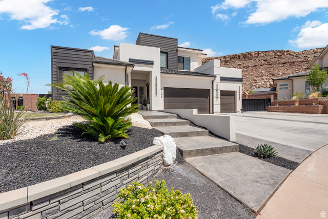 6105 Bunda Way St. George, UT 84790 - Photo 47 of 49 Modern architectural exterior featuring white stucco, dark paneling, and a multi-level design