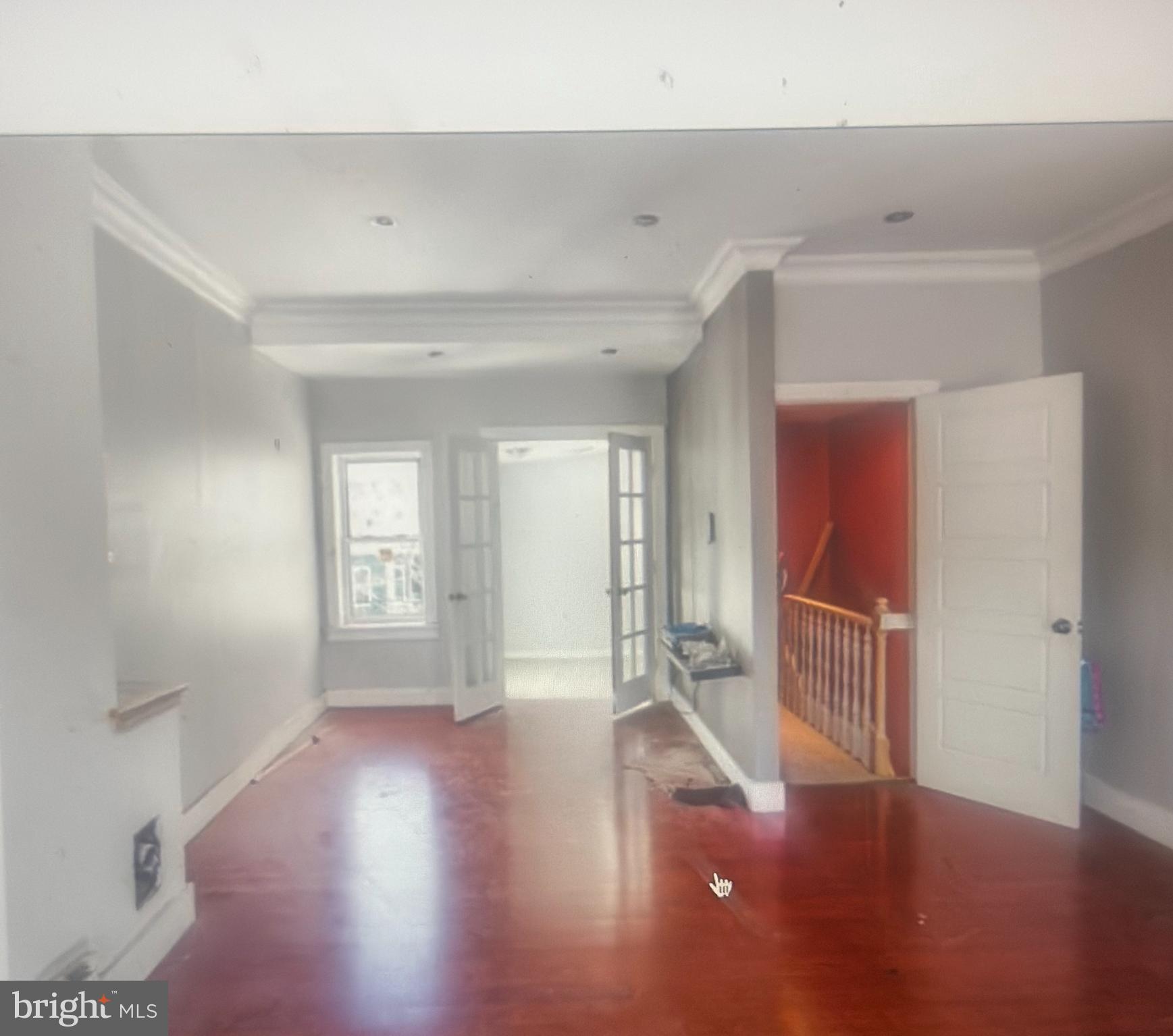 1925 North 23rd Street Philadelphia, PA 19121 - Photo 8 of 11 a view of an empty room with wooden floor and a window
