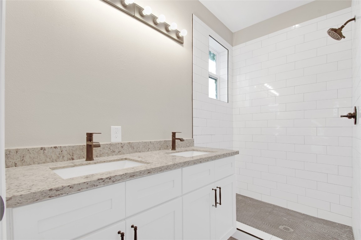 4913 Single Shot Circle, Unit B Austin, TX 78723 - Photo 14 of 21 a bathroom with a granite countertop sink and a mirror