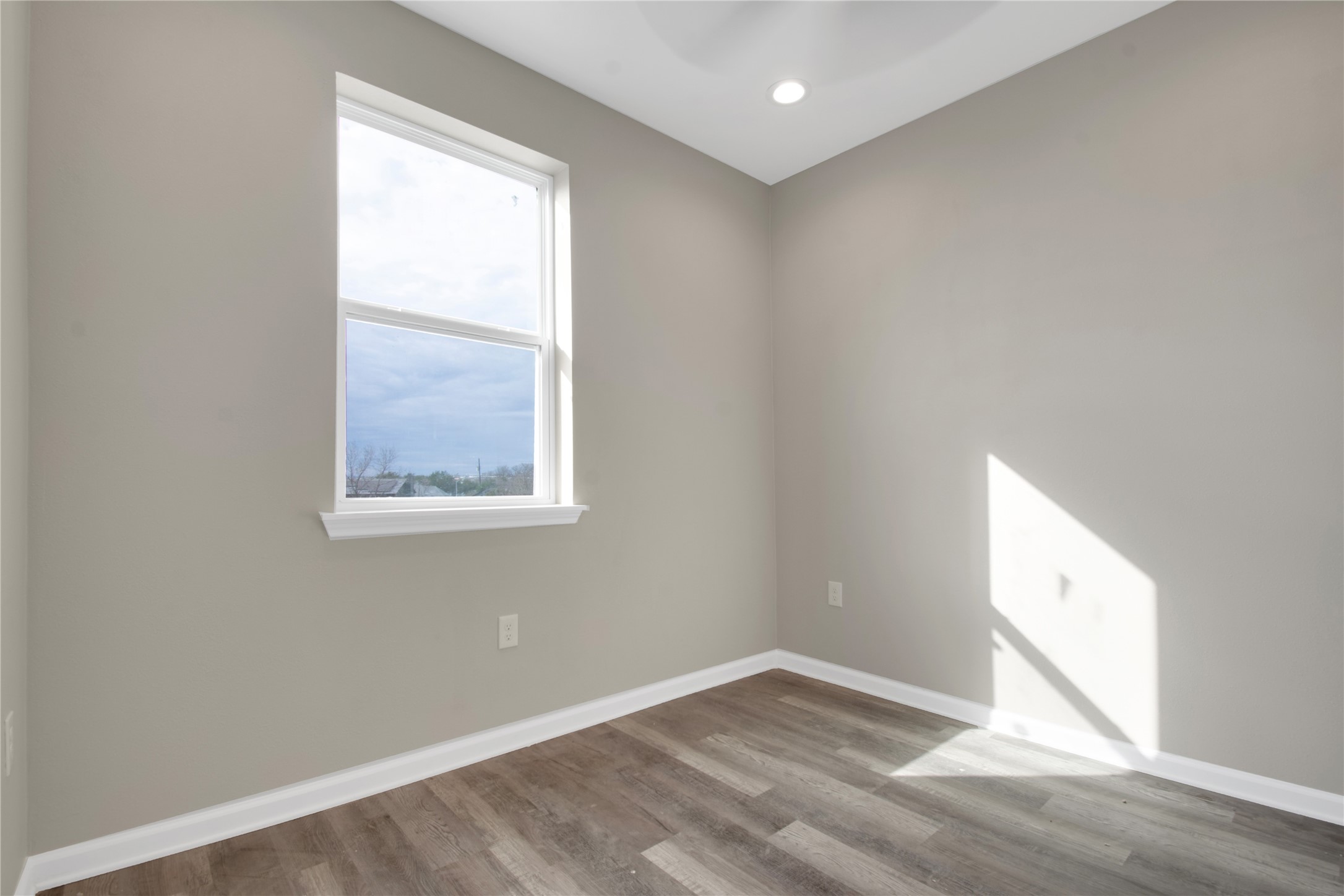 4913 Single Shot Circle, Unit B Austin, TX 78723 - Photo 17 of 21 an empty room with wooden floor and windows