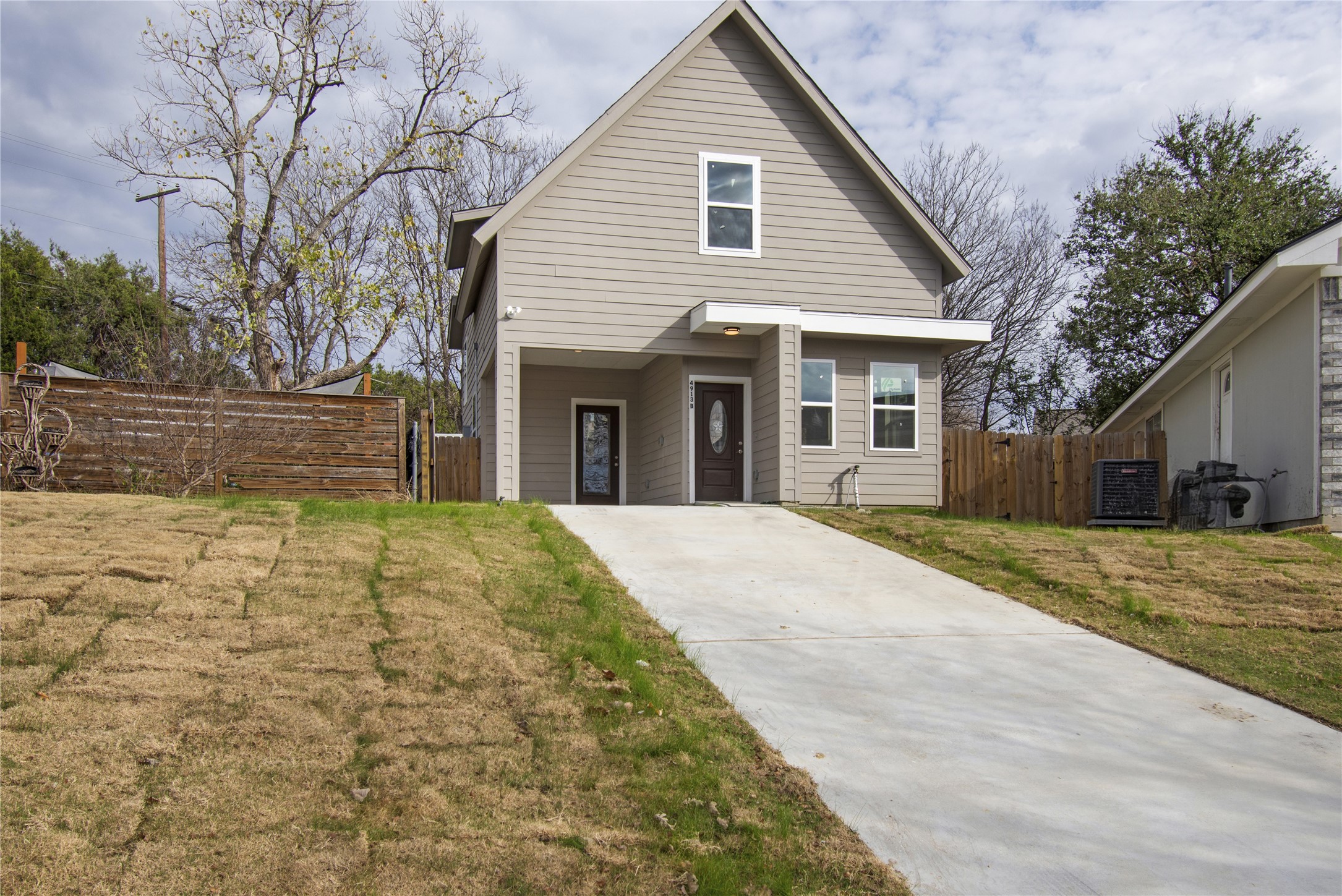 4913 Single Shot Circle, Unit B Austin, TX 78723 - Photo 2 of 21 a view of a white house with a large tree