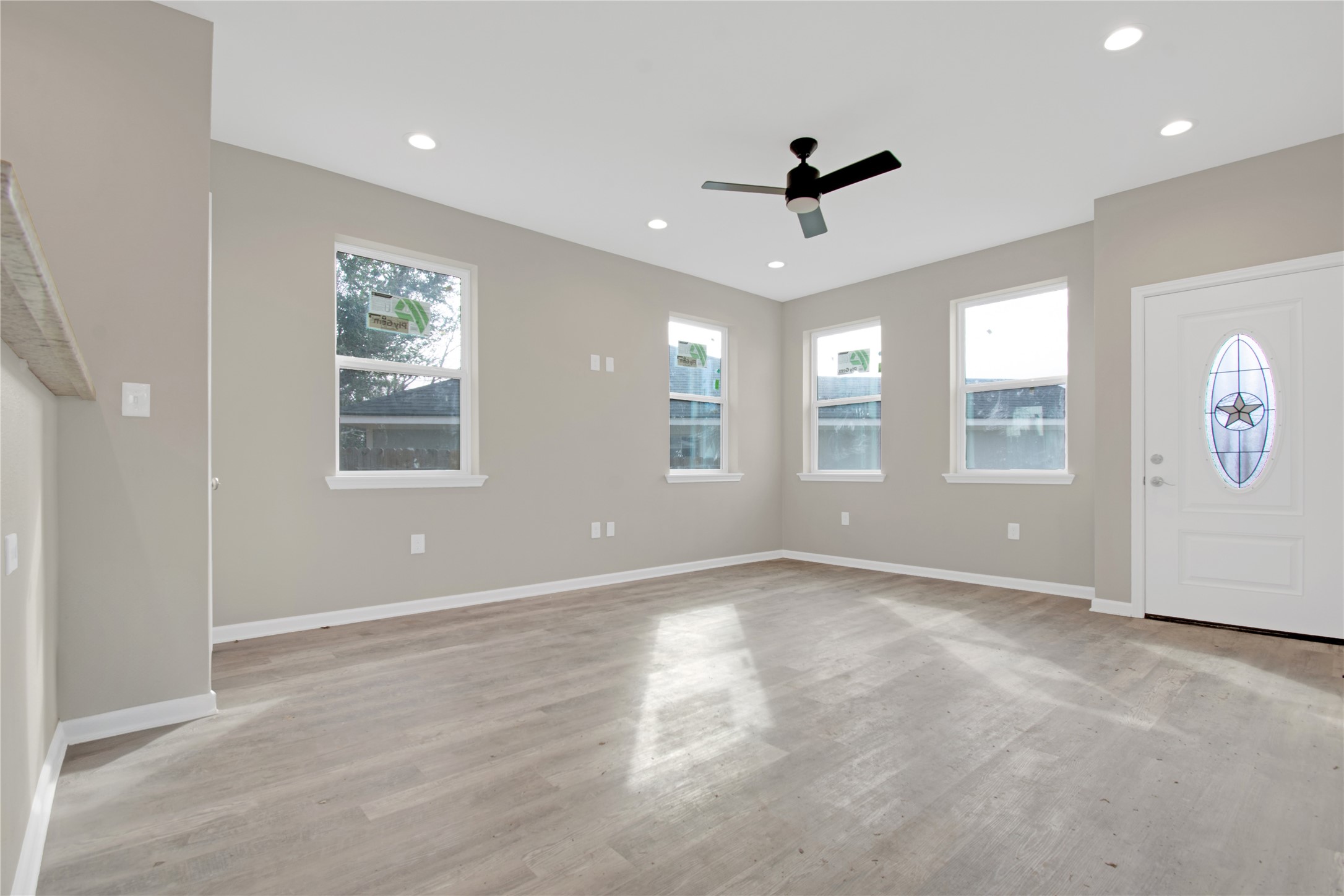 4913 Single Shot Circle, Unit B Austin, TX 78723 - Photo 6 of 21 a view of an empty room with a window and wooden floor