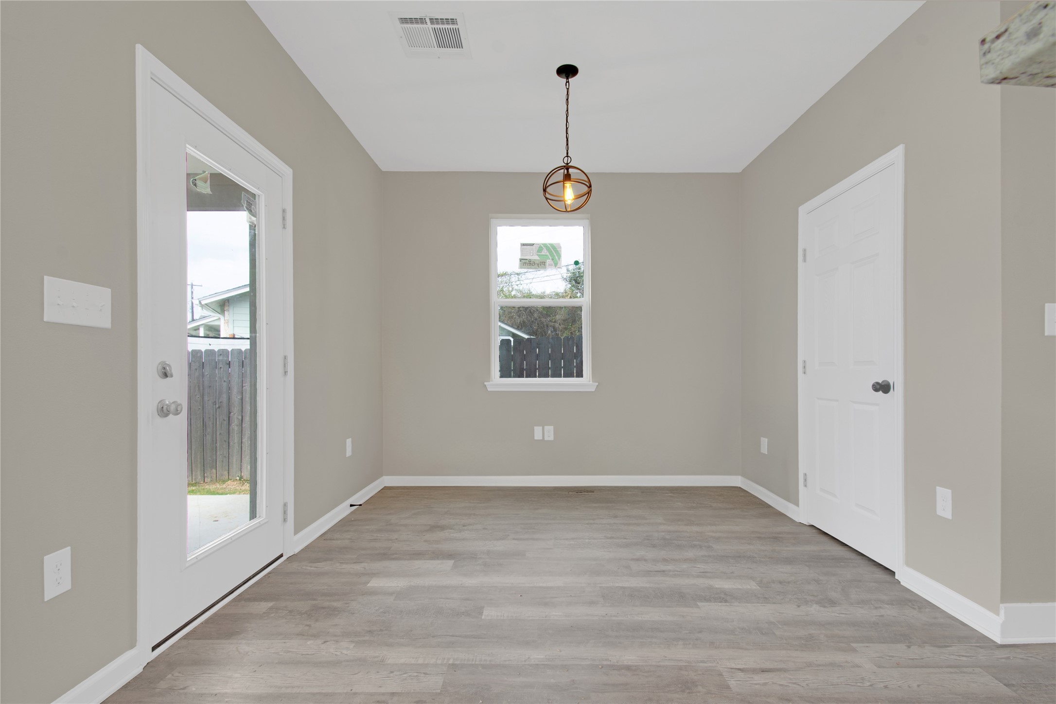 4913 Single Shot Circle, Unit B Austin, TX 78723 - Photo 10 of 21 a view of an empty room with wooden floor and a window