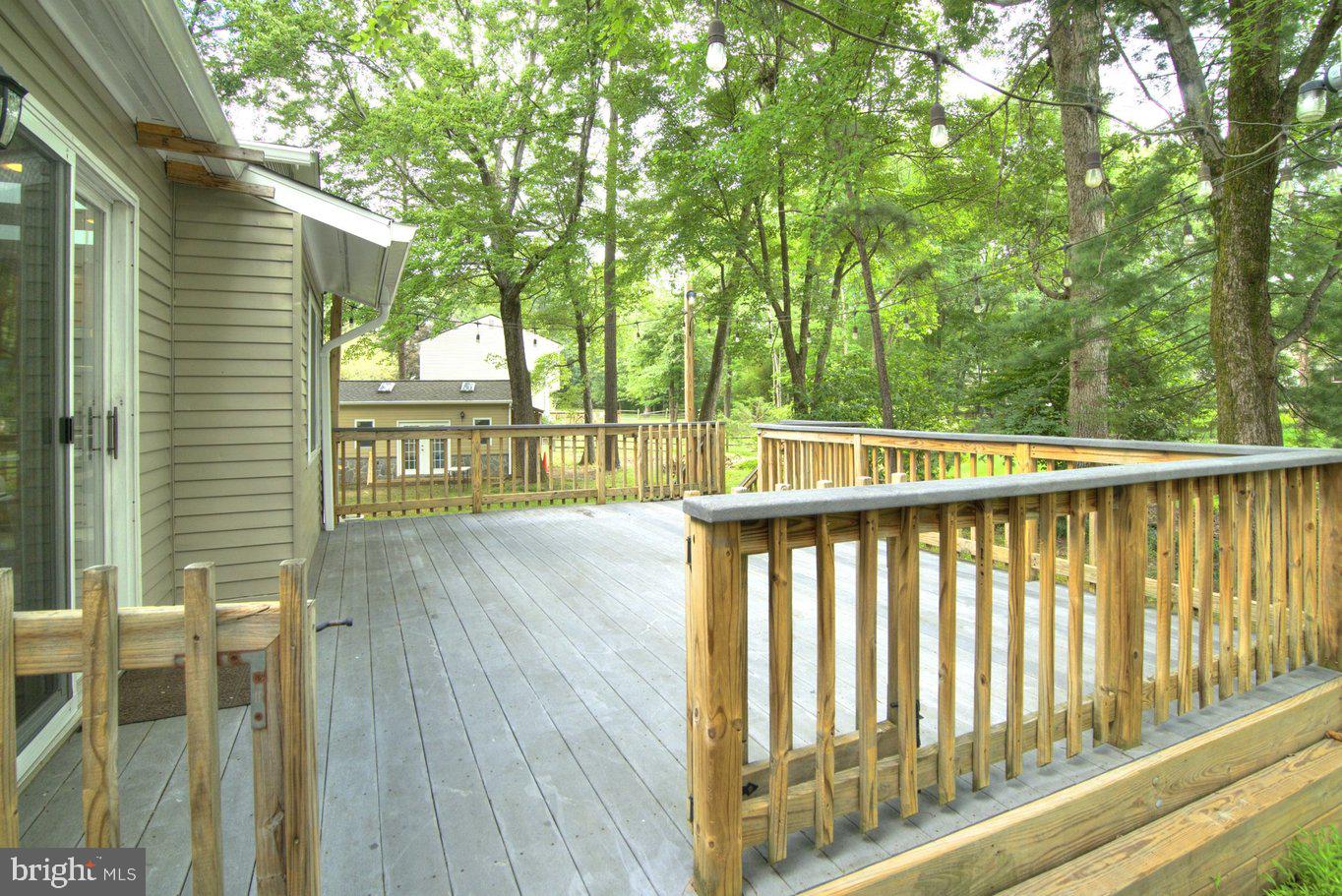 Serene deck nestled in lush greenery.