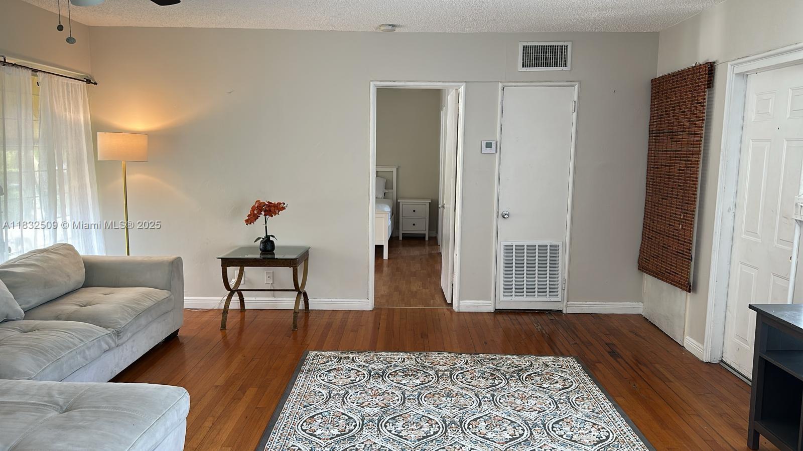90 Isle Of Venice Drive, Unit 9 Fort Lauderdale, FL 33301 - Photo 2 of 7 a living room with furniture and a rug