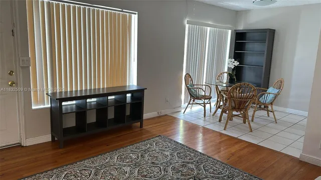 a dining room with furniture and wooden floor