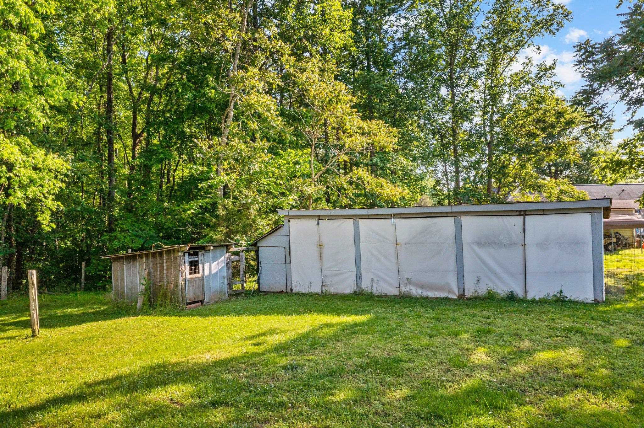 500 Tingen Mine Road Roxboro, NC 27574 - Photo 13 of 39 a view of a backyard with potted plants and large tree
