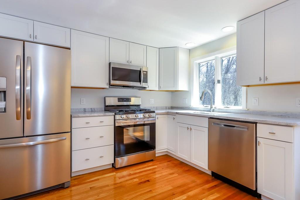 17 Longmeadow Road Medfield, MA 02052 - Photo 5 of 18 a kitchen with stainless steel appliances a refrigerator stove and microwave
