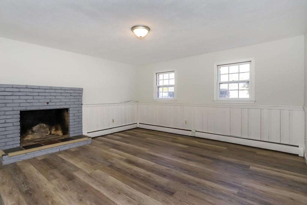 17 Longmeadow Road Medfield, MA 02052 - Photo 10 of 18 an empty room with wooden floor fire place and windows
