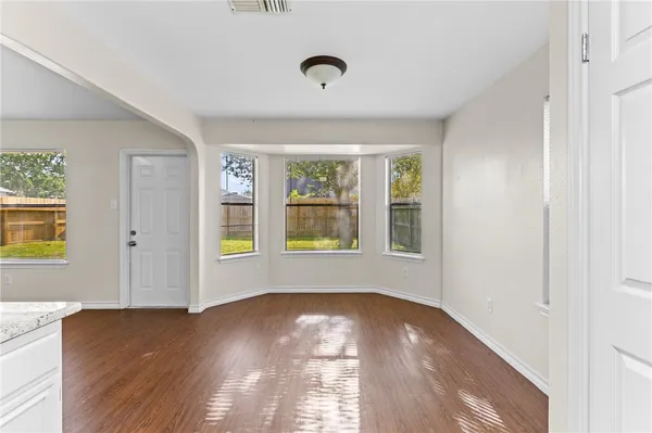 a view of livingroom with window wooden floor and front door