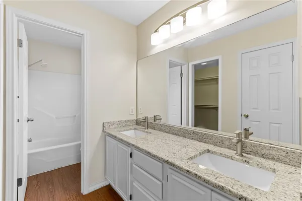 a bathroom with a granite countertop sink mirror and double