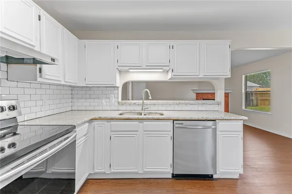 a kitchen with appliances cabinets and a sink