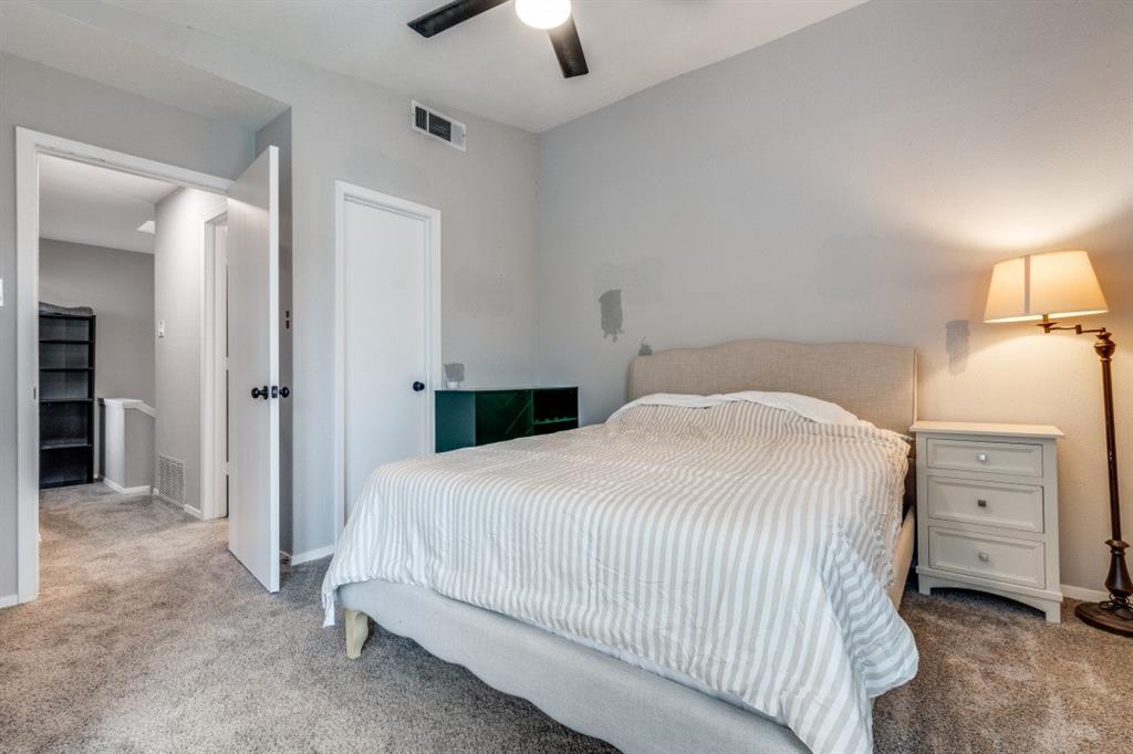 6900 Skillman Street, Unit 109 Dallas, TX 75231 - Photo 16 of 21 a bedroom with a bed and a lamp