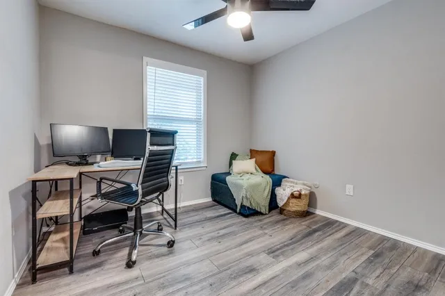 a workspace with furniture window and wooden floor