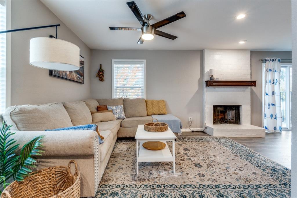 6900 Skillman Street, Unit 109 Dallas, TX 75231 - Photo 3 of 21 a living room with furniture and a fireplace
