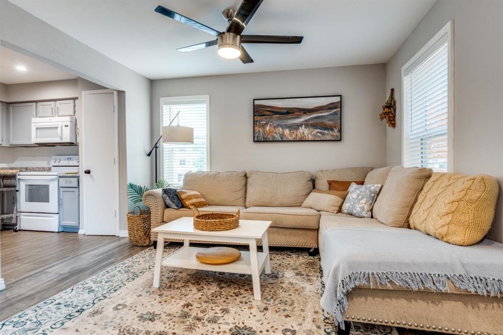 6900 Skillman Street, Unit 109 Dallas, TX 75231 - Photo 6 of 21 a living room with furniture and a wooden floor
