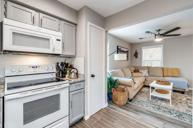 a kitchen with stainless steel appliances white cabinets and a stove