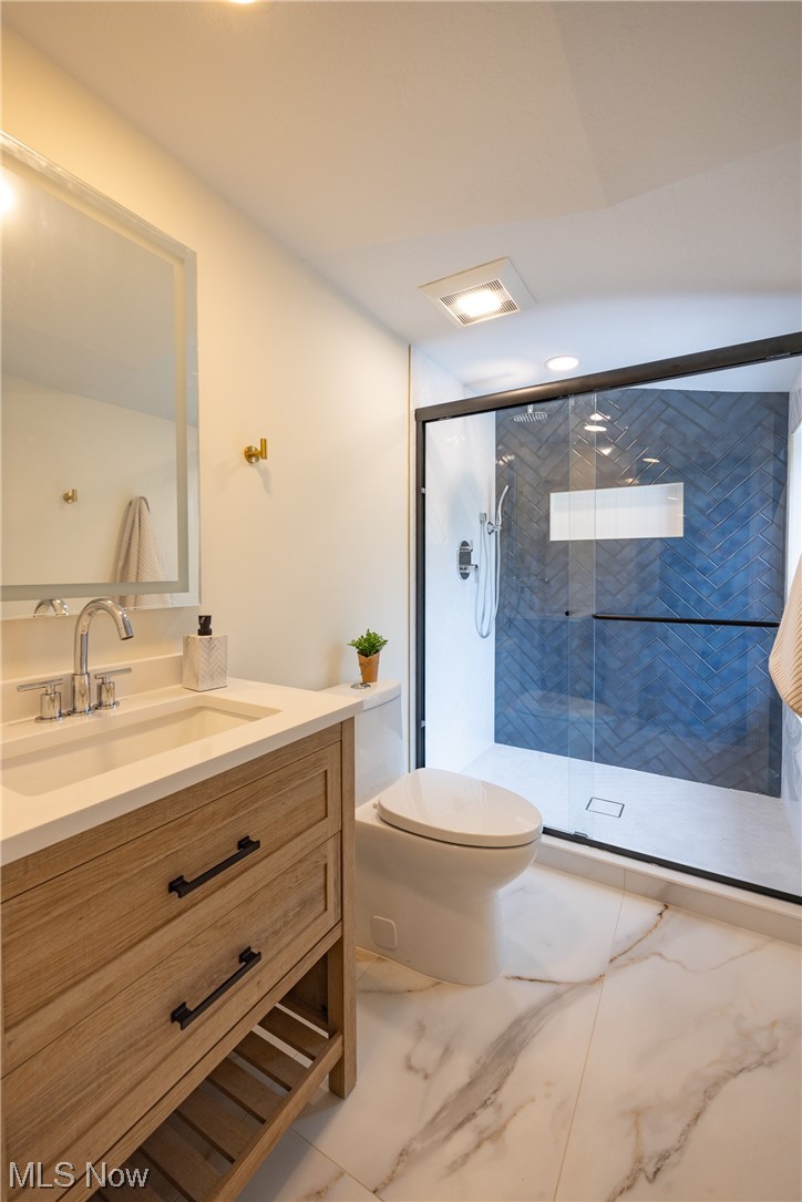 32887 Cedar Road Mayfield Heights, OH 44124 - Photo 29 of 44 Bathroom with large vanity, a shower with shower door, tile floors, and toilet