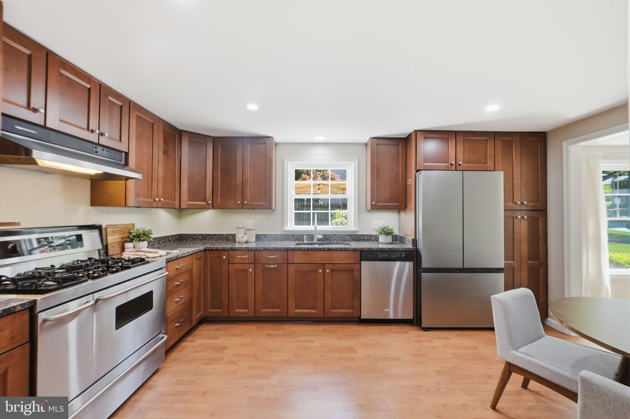 8008 Inspection House Road Potomac, MD 20854 - Photo 5 of 43 Modern kitchen with warm wood tones.