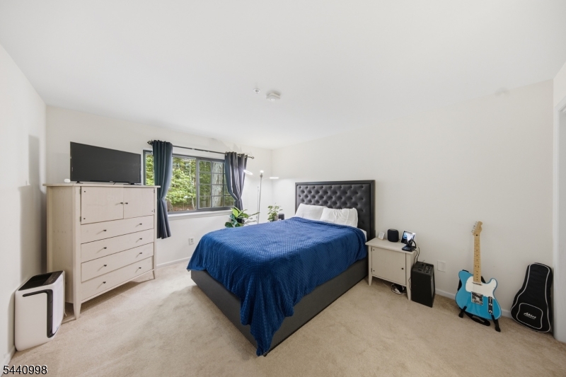 609 Mark Twain Way Mahwah, NJ 07430 - Photo 13 of 40 a bedroom with a bed and chair
