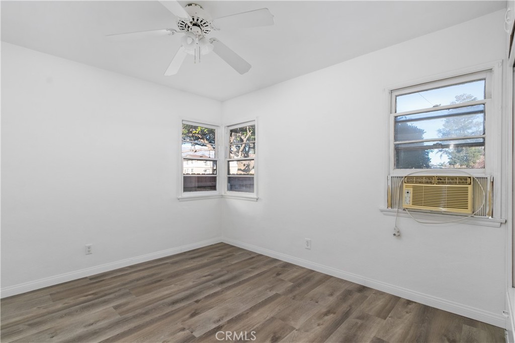 725 Michigan Avenue Beaumont, CA 92223 - Photo 15 of 20 an empty room with a chandelier fan and windows