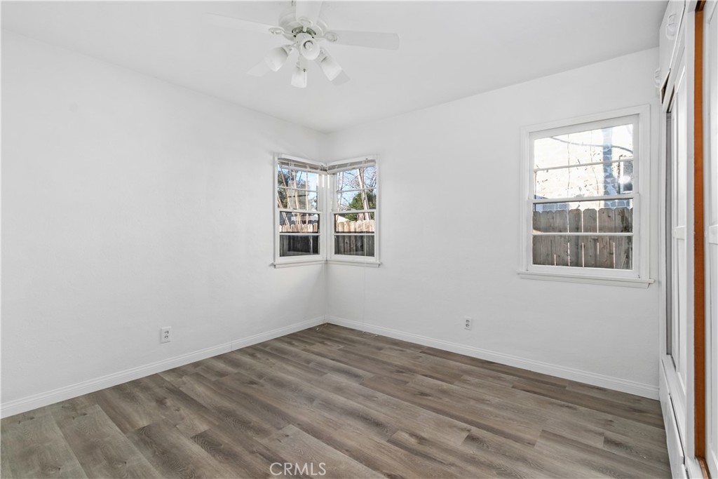725 Michigan Avenue Beaumont, CA 92223 - Photo 10 of 20 an empty room with wooden floor and windows