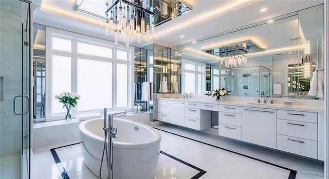 a large white bathroom with a large window and sink