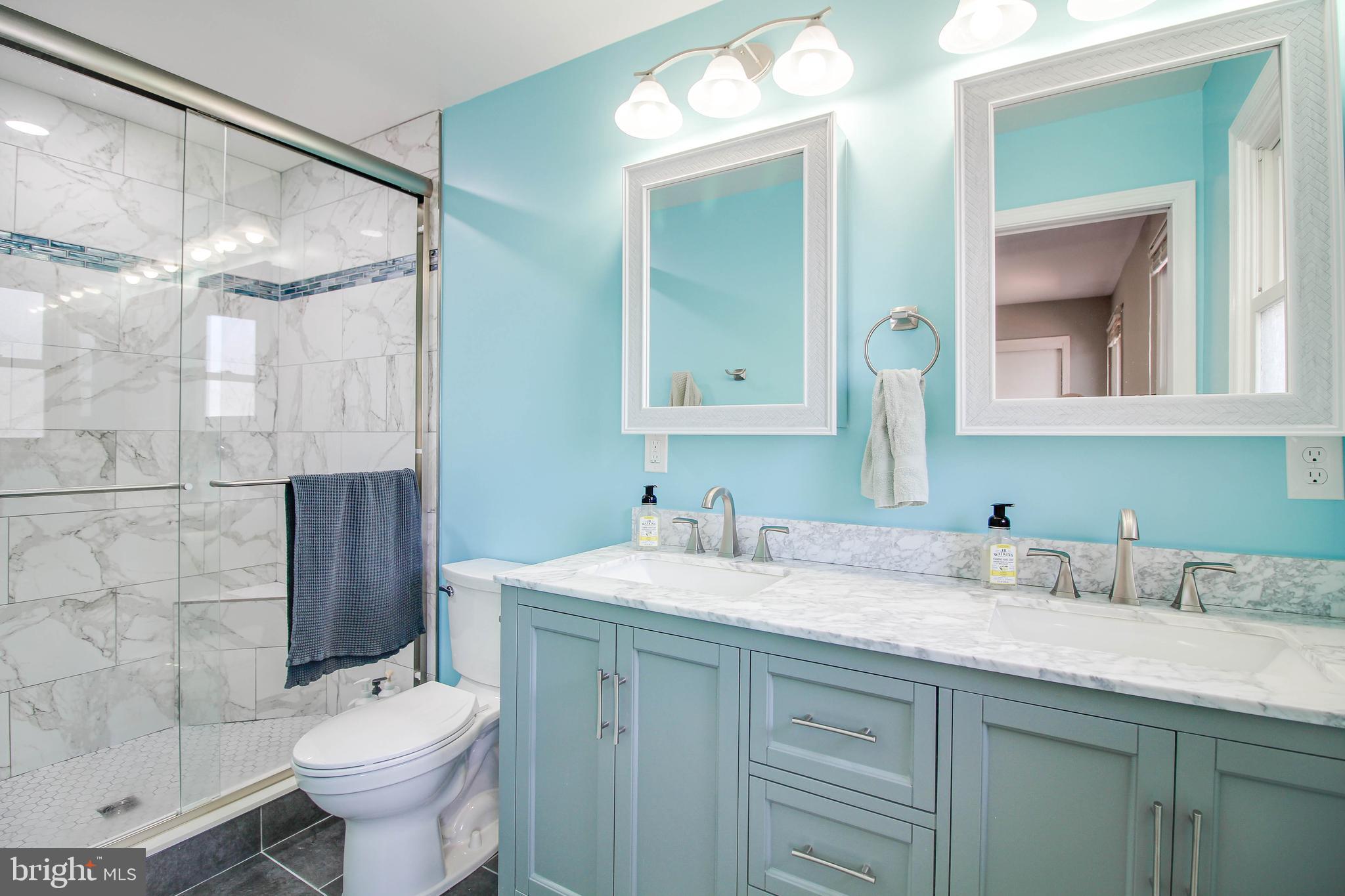 2408 Old Frederick Road Catonsville, MD 21228 - Photo 19 of 53 a bathroom with a sink toilet double vanity and shower
