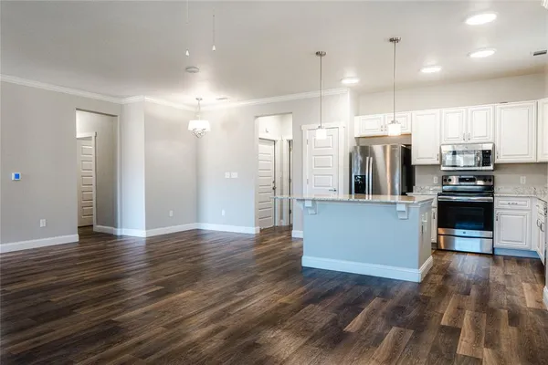 a view of kitchen with stainless steel appliances refrigerator oven and stove