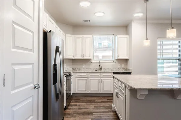 a kitchen with a sink stove and refrigerator