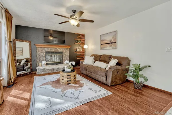 a living room with furniture and a fireplace