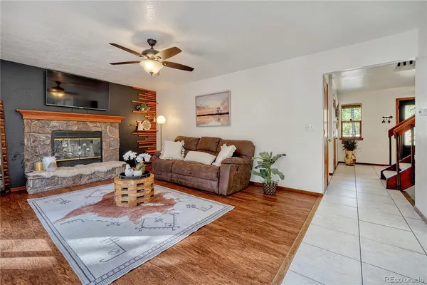 a living room with furniture and a fireplace