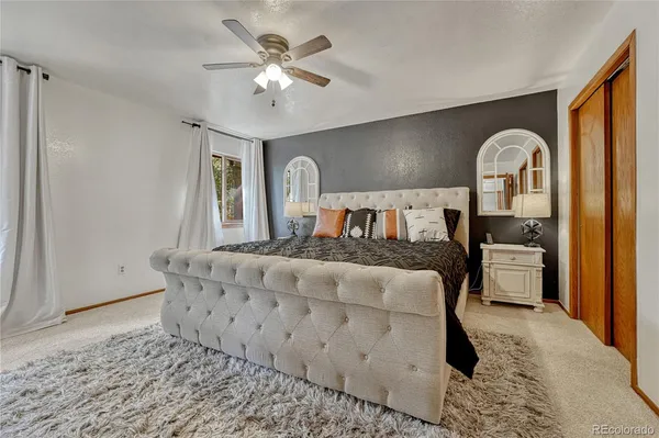 a bed room with a bed and a chandelier