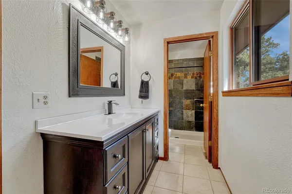 a bathroom with a sink a vanity and a mirror