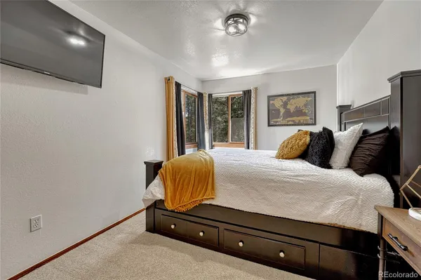 a bedroom with a bed and a chandelier