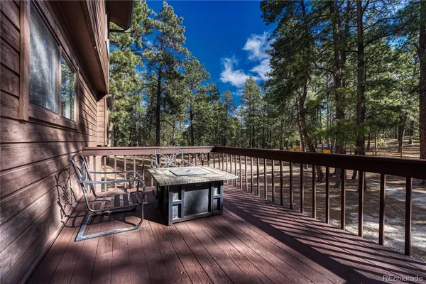 a view of balcony with wooden floor and seating space