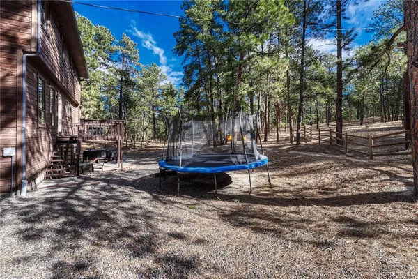 a backyard of a house with fountain table and chairs