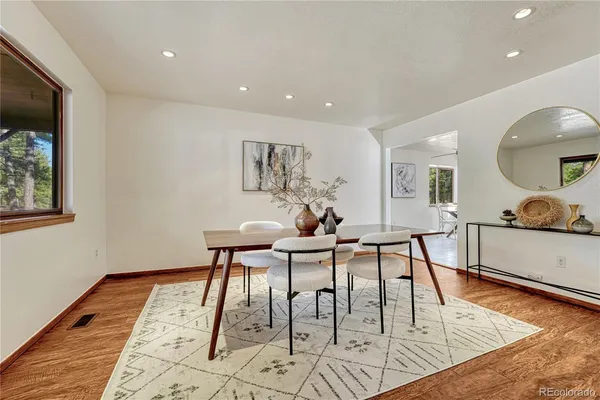 a view of a dining room with furniture and wooden floor